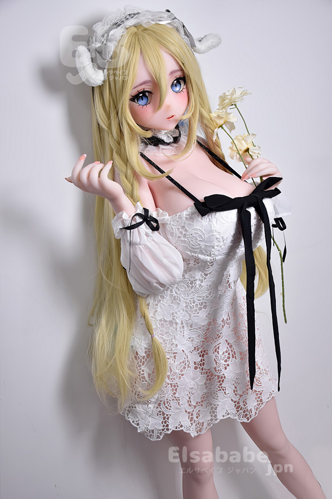 Life-sized anime-style doll with long blonde hair in a white lace off-shoulder dress, holding pale flowers against a plain background.
