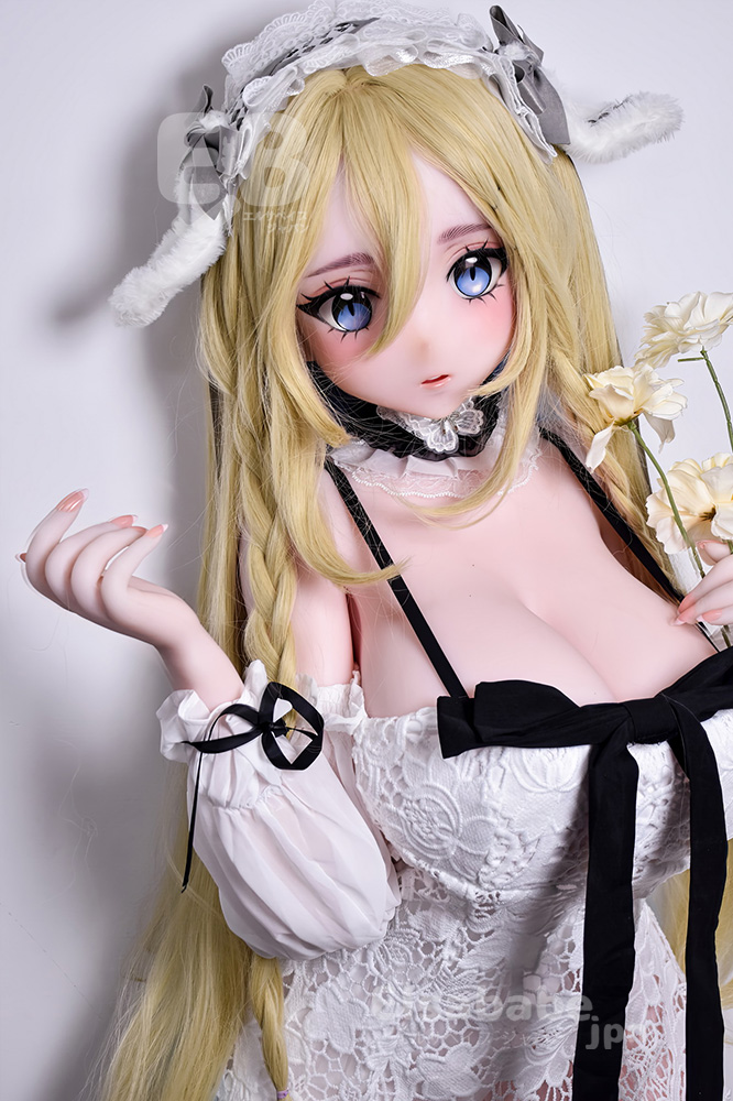 Anime-style doll with long blonde hair and blue eyes, wearing a white lace dress with a black bow and lace headband, holding pale flowers.