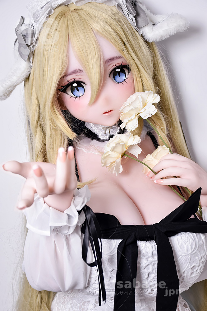 Cosplay doll with long blonde hair and blue eyes, wearing a white lace dress with a black ribbon, offering white flowers toward the viewer.