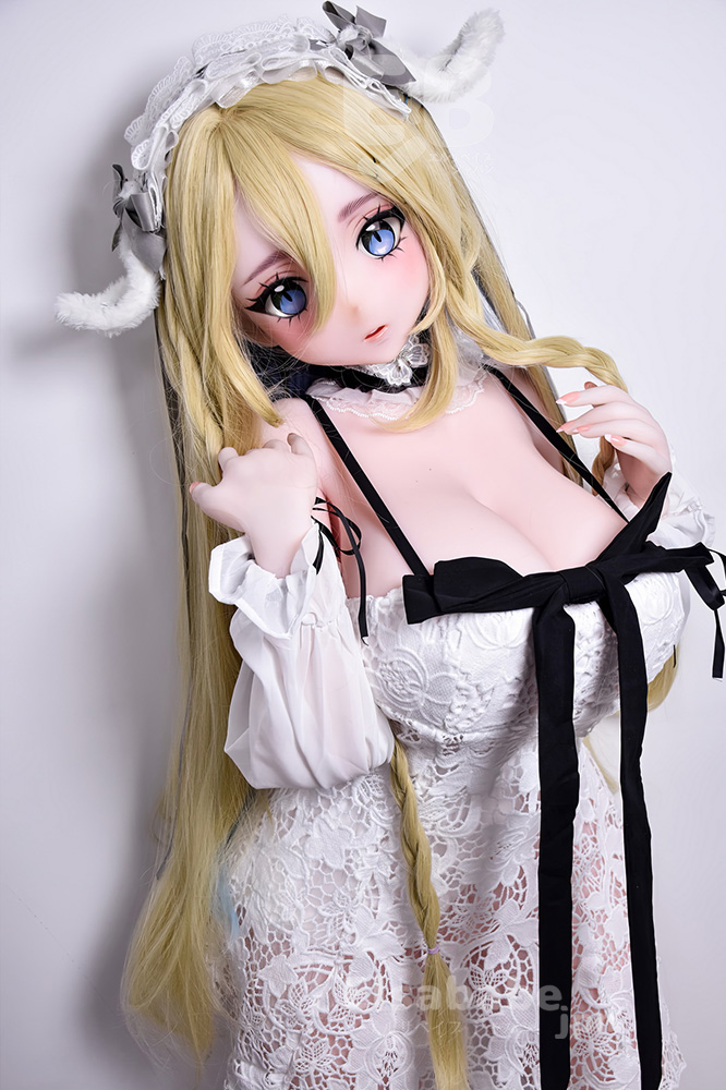 Life-like doll in a white lace maid outfit with long blonde hair and blue eyes, wearing a lace headband with bunny ears, posing close to the camera.