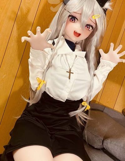 Cosplay of a catgirl with long silver hair, yellow bows, black shorts, white blouse, and cross necklace, reaching toward the camera.