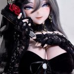 Gothic fashion doll with silver hair, blue eyes, and black lace clothing, posing with lace gloves and a red rose accent.