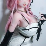 Anime-style doll with pink hair and elf ears wearing a white lace dress with black accents, posing against a light background
