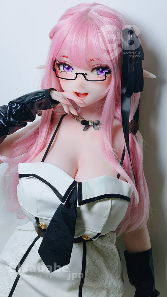 Cosplayer with pink hair and glasses in a white and black-trimmed dress with long black gloves, posing with a finger to the lips.