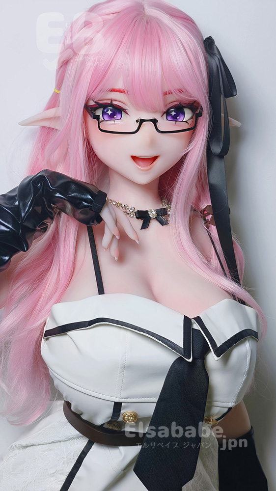 Life-size anime-style doll with pink hair, elf ears, glasses, and a white-and-black outfit posing with hand near the chin.