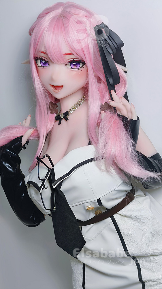 Cosplay doll with pink hair and elf-like ears, posing with hands in her hair, wearing a white and black outfit with a beaded necklace.