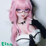 Life-size anime doll with long pink hair, elf ears, purple eyes, wearing glasses and a black-and-white outfit, posing with a finger to her lips to the camera.