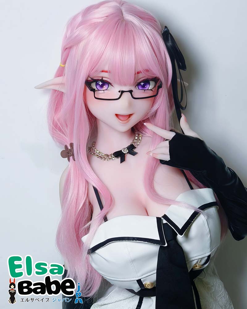 Life-size anime doll with long pink hair, elf ears, purple eyes, wearing glasses and a black-and-white outfit, posing with a finger to her lips to the camera.